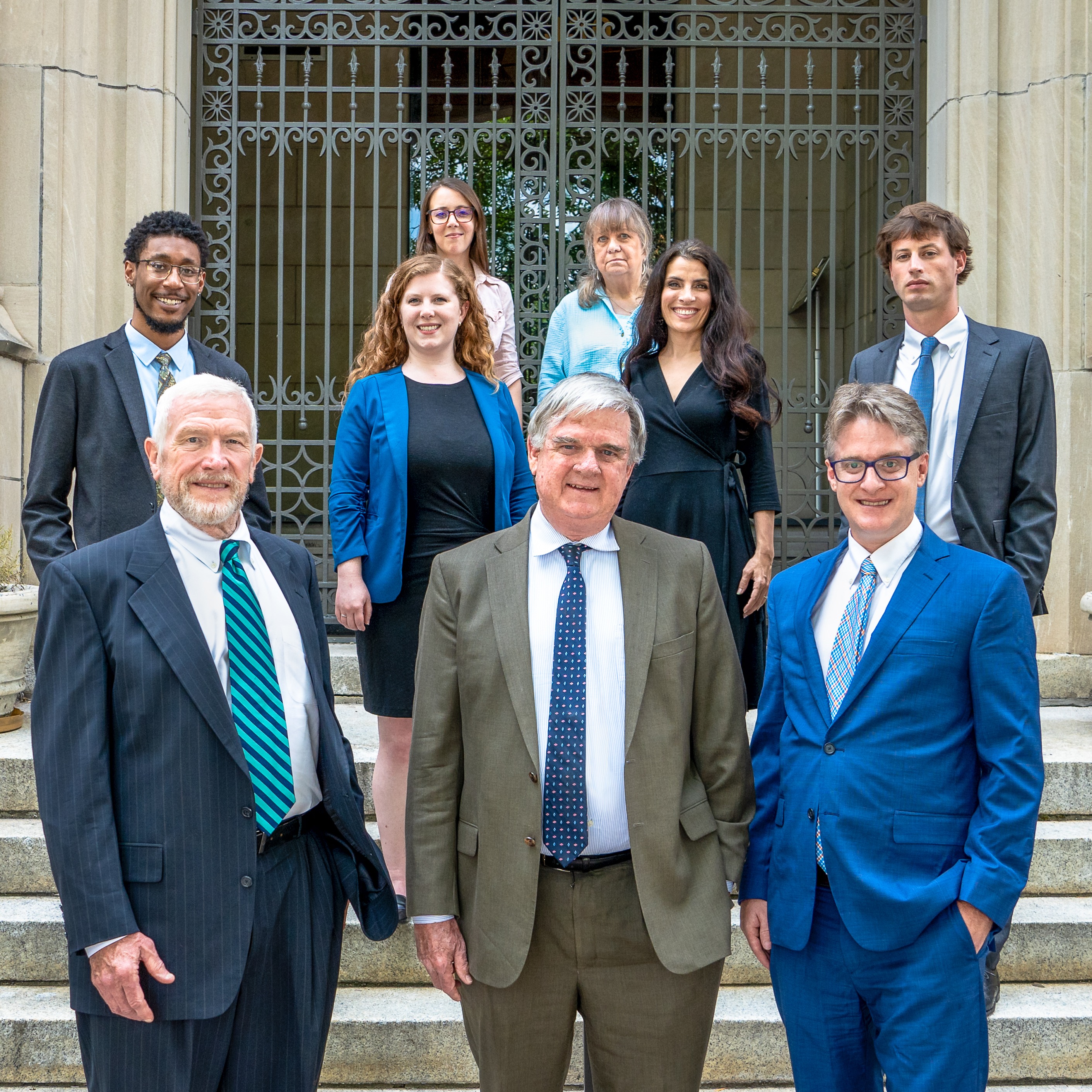 law firm staff standing in front of doors